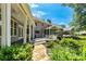Expansive backyard with stone path, lush landscaping, a screened-in porch and covered outdoor living space at 115 Edgewater Way, Peachtree City, GA 30269