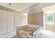 Bright bathroom featuring a soaking tub, large window, and a double-door closet at 115 Edgewater Way, Peachtree City, GA 30269