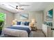 Bright bedroom with ceiling fan, large window, and coordinated nautical decor at 115 Edgewater Way, Peachtree City, GA 30269