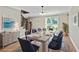 Elegant dining room featuring a large table, stylish chairs, and ample natural light at 115 Edgewater Way, Peachtree City, GA 30269