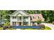Stunning Peachtree Lake home in Peachtree City with traditional architecture and manicured lawn at 115 Edgewater Way, Peachtree City, GA 30269