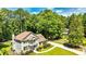 Charming two-story home featuring a beautifully landscaped yard and welcoming front porch with white railings and a lush tree line at 115 Edgewater Way, Peachtree City, GA 30269