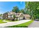Charming two-story home with attached garage, mature trees, lush landscaping and circular driveway at 115 Edgewater Way, Peachtree City, GA 30269