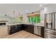Modern kitchen with stainless steel appliances, quartz countertops, and open layout at 115 Edgewater Way, Peachtree City, GA 30269