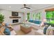 Bright living room features a fireplace, large windows, and comfortable seating at 115 Edgewater Way, Peachtree City, GA 30269