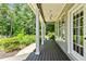 Covered porch with stone pathway, ceiling fan, traditional columns, view to backyard and private grounds at 115 Edgewater Way, Peachtree City, GA 30269