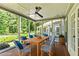 Inviting screened porch featuring a dining table and comfortable seating at 115 Edgewater Way, Peachtree City, GA 30269