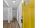 Bright entryway with hardwood flooring, white trim, and a distinctive yellow front door at 1400 North Avenue Nw, Atlanta, GA 30318