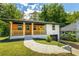 Charming home featuring a blend of wood and painted siding, covered porch, and a bright yellow front door at 1400 North Avenue Nw, Atlanta, GA 30318