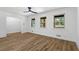 Bright living room featuring wood-look flooring, white walls, and three windows overlooking the front yard at 1400 North Avenue Nw, Atlanta, GA 30318