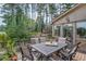Relaxing back deck with a dining table and chairs overlooking the scenic greenery at 2380 Tayside Nw Xing, Kennesaw, GA 30152