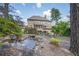 Exterior view of the home, showcasing a lush backyard with a pond, and mature landscaping at 2380 Tayside Nw Xing, Kennesaw, GA 30152