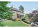 Spacious backyard featuring lush landscaping, stone steps, and a glimpse of the pool area at 2380 Tayside Nw Xing, Kennesaw, GA 30152