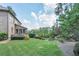 Manicured lawn and landscaping create a serene backyard oasis at 2380 Tayside Nw Xing, Kennesaw, GA 30152