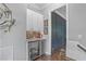 Wet bar area with sleek cabinets, wine cooler, and decorative backsplash for easy entertaining at 2380 Tayside Nw Xing, Kennesaw, GA 30152