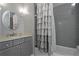 Bathroom featuring a vanity with granite countertop, framed mirror, and tiled bathtub at 2380 Tayside Nw Xing, Kennesaw, GA 30152