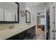 Bathroom featuring a double vanity with granite countertop, framed mirrors, and view to the bedroom at 2380 Tayside Nw Xing, Kennesaw, GA 30152