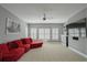 Comfortable bonus room offering a red sectional sofa, ceiling fan, and large tv screen at 2380 Tayside Nw Xing, Kennesaw, GA 30152