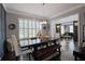 Elegant dining room with a large window, stylish light fixture, and seamless access to the piano room at 2380 Tayside Nw Xing, Kennesaw, GA 30152