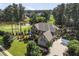 Stunning two-story brick home featuring a golf course view, lush landscaping, and a spacious driveway at 2380 Tayside Nw Xing, Kennesaw, GA 30152