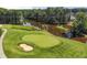 Aerial view of a golf course with a pond, showcasing a sand trap and the surrounding landscape at 2380 Tayside Nw Xing, Kennesaw, GA 30152