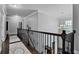 Bright hallway featuring hardwood floors, decorative chandelier, and wrought iron railing at 2380 Tayside Nw Xing, Kennesaw, GA 30152