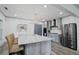 Modern kitchen features granite island with seating, stainless appliances, and stylish lighting at 2380 Tayside Nw Xing, Kennesaw, GA 30152