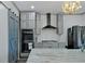 Stylish kitchen boasts gray cabinets, stainless steel appliances, and sliding barn door at 2380 Tayside Nw Xing, Kennesaw, GA 30152
