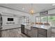 Open kitchen with farmhouse sink, granite countertops, stainless steel appliances, and adjoining living area at 2380 Tayside Nw Xing, Kennesaw, GA 30152