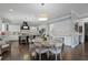 Modern kitchen with white cabinets, stainless steel appliances, large island, and dining area at 2380 Tayside Nw Xing, Kennesaw, GA 30152
