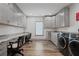Spacious laundry room featuring abundant grey cabinets, marble countertops, and hardwood floors at 2380 Tayside Nw Xing, Kennesaw, GA 30152
