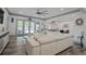 Spacious living room with white sofa, large windows, ceiling fan, and open to kitchen at 2380 Tayside Nw Xing, Kennesaw, GA 30152