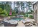 Backyard with an in-ground pool, lounge chairs, mature trees and lush landscaping creates a resort-like feel at 2380 Tayside Nw Xing, Kennesaw, GA 30152