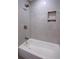 Bright bathroom showcasing a tiled shower with a tub, and marble tiled walls at 260 Lakemont Dr, Roswell, GA 30075