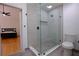Contemporary bathroom featuring a glass shower, neutral tile, and modern fixtures near the bedroom at 260 Lakemont Dr, Roswell, GA 30075