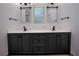 Bathroom with a dual sink vanity, modern fixtures, and framed mirrors at 260 Lakemont Dr, Roswell, GA 30075