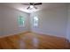 Bright bedroom featuring hardwood floors, and two windows, a ceiling fan at 260 Lakemont Dr, Roswell, GA 30075