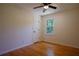 Bright bedroom featuring hardwood floors, a ceiling fan, and a window with a view of trees at 260 Lakemont Dr, Roswell, GA 30075