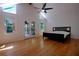 Bright bedroom with hardwood floors, a vaulted ceiling, natural light, and french doors to a balcony at 260 Lakemont Dr, Roswell, GA 30075
