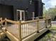 Spacious new wood deck with black metal railing, ideal for outdoor entertaining and relaxation at 260 Lakemont Dr, Roswell, GA 30075