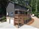 Charming exterior elevation showcasing a two-story home with a porch, garage, and stone foundation at 260 Lakemont Dr, Roswell, GA 30075