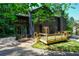 View of the home with a spacious deck and porch with trees, perfect for relaxing and enjoying the outdoors at 260 Lakemont Dr, Roswell, GA 30075