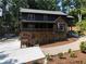 Exterior shot of the home with a porch and driveway at 260 Lakemont Dr, Roswell, GA 30075