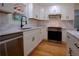 Beautiful kitchen featuring white cabinets, stainless steel appliances, marble countertops, and sleek, dark hardware at 260 Lakemont Dr, Roswell, GA 30075