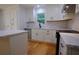 Modern kitchen featuring an island, white cabinets, marble countertops, and stainless steel appliances at 260 Lakemont Dr, Roswell, GA 30075