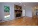 Inviting living room with a stone fireplace, hardwood floors, bright lighting, and outdoor views at 260 Lakemont Dr, Roswell, GA 30075