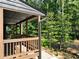 Detailed view of the wooden porch, railing, and surrounding greenery, with a glimpse of the home's exterior at 260 Lakemont Dr, Roswell, GA 30075