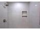 Shower featuring marble tiling with a niche, a rain shower head, and sleek hardware at 260 Lakemont Dr, Roswell, GA 30075