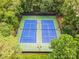 Aerial view of two well maintained tennis courts with surrounding mature trees at 3506 Billingsley Dr, Marietta, GA 30062