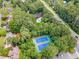 Bird's eye view of tennis courts and pool surrounded by lush trees and the neighborhood at 3506 Billingsley Dr, Marietta, GA 30062